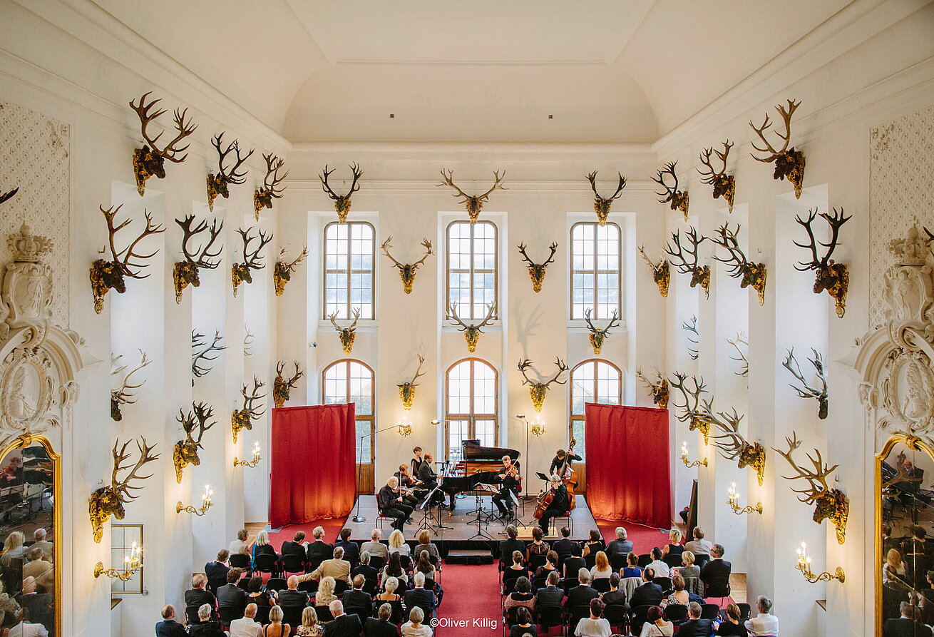 Moritzburg Festival Concert in historic hall with deer antlers stage and audience