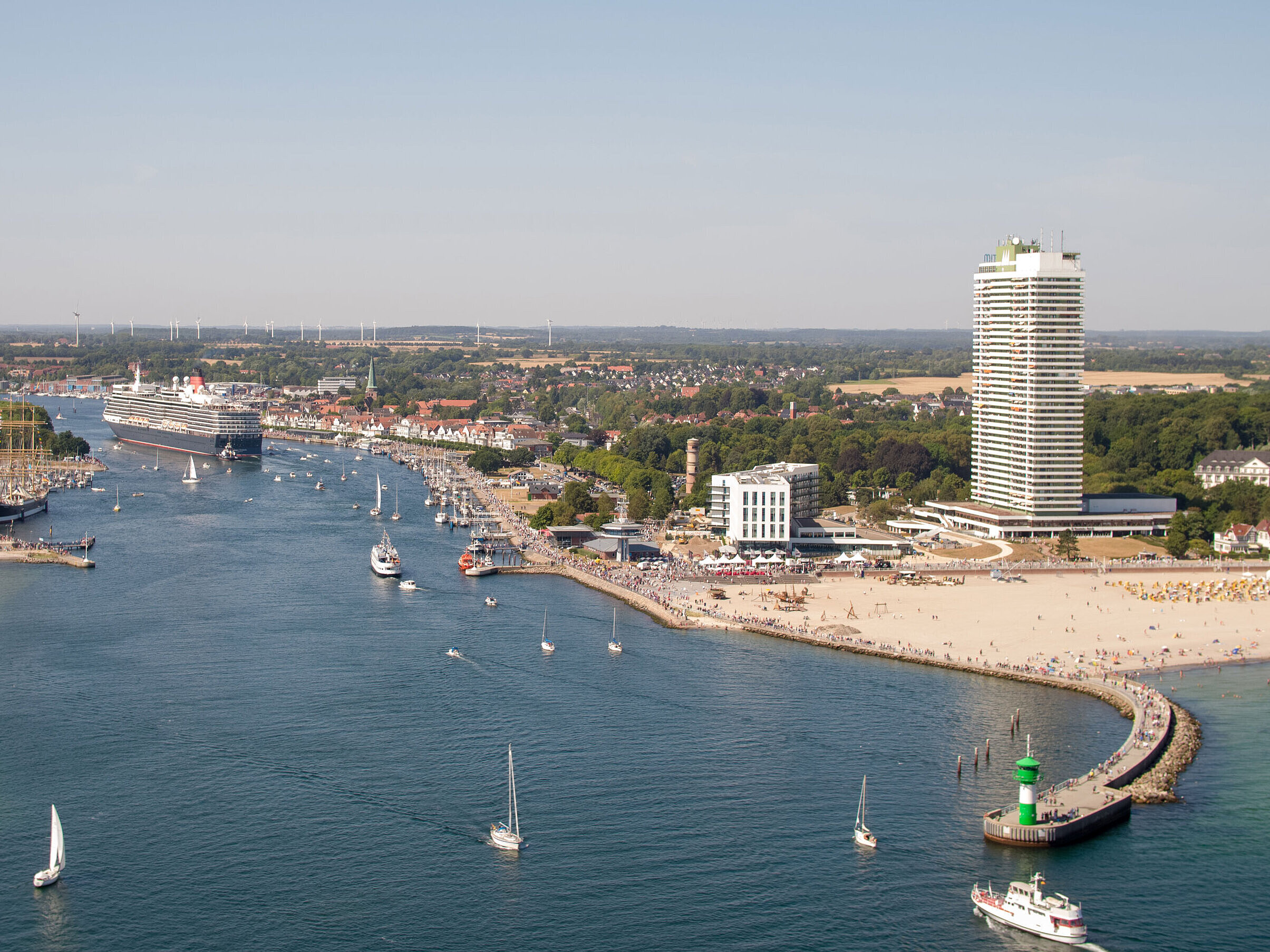 Aerial view of Travemünde with cruise ship, promenade and Maritim Hotel by the Baltic Sea