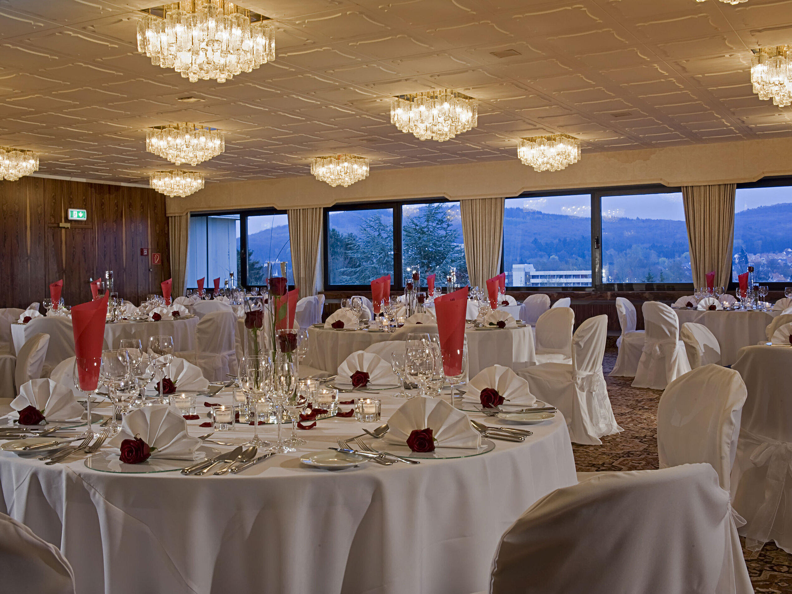 Spacious banquet hall with round tables and elegant decor at Maritim Hotel Bad Salzuflen