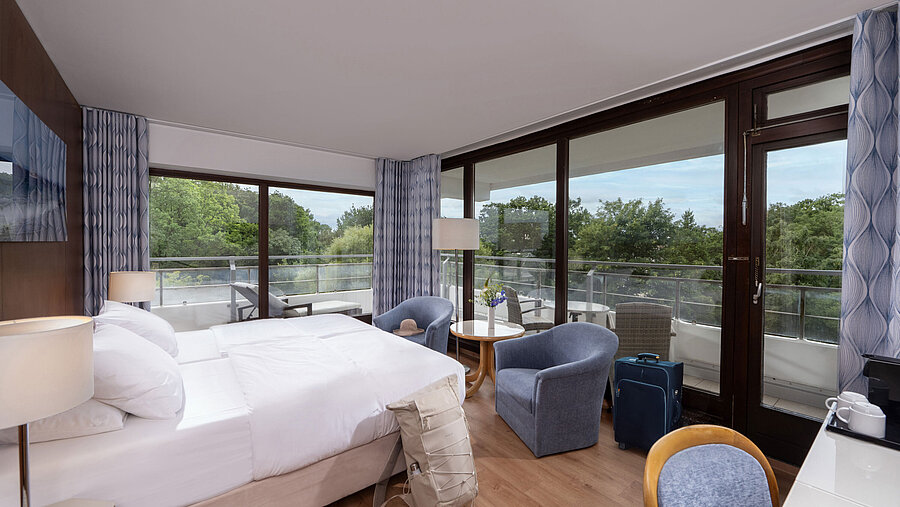 Modern double room at Maritim Seehotel Timmendorfer Strand with balcony and garden view