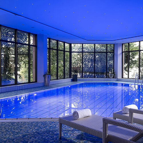 The stylish indoor pool at Maritim Hotel Bad Homburg offers a soothing ambiance with soft lighting and comfortable loungers.