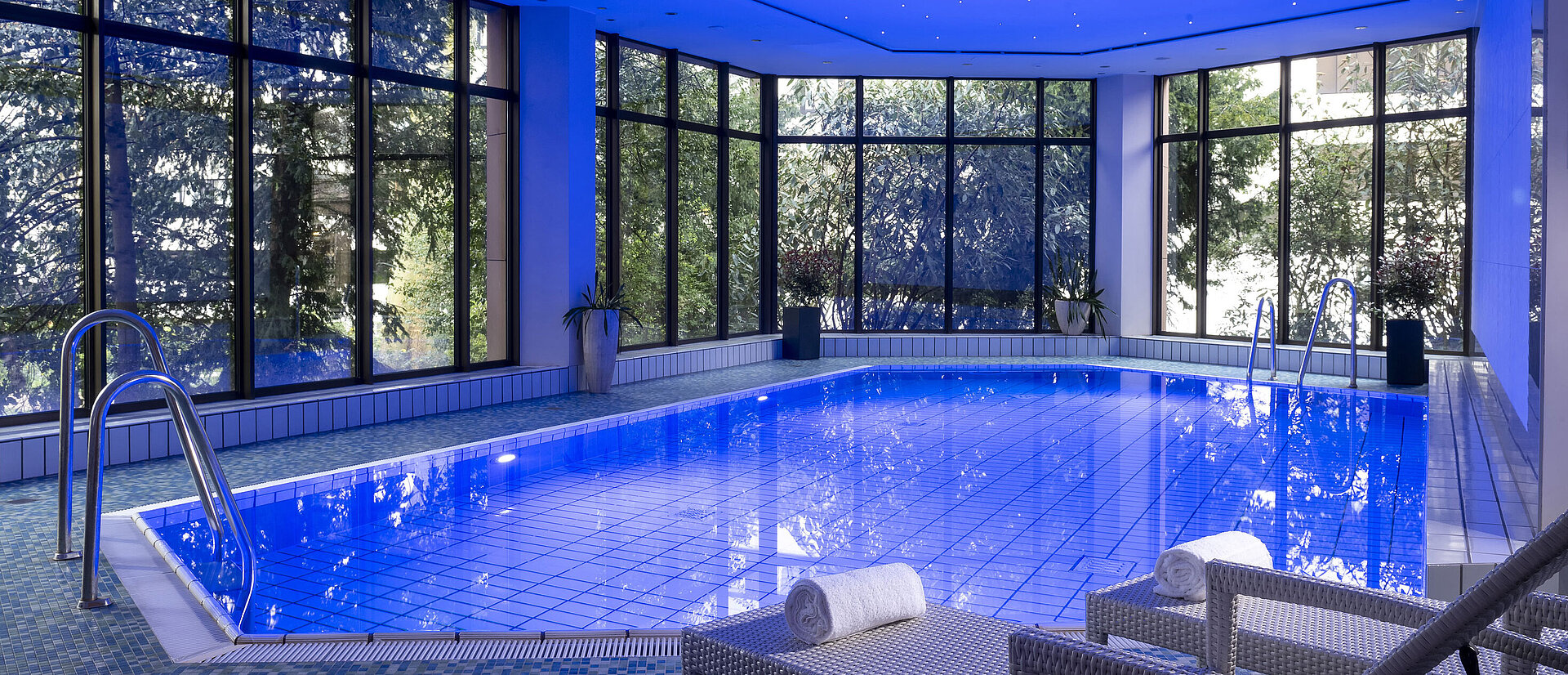 The stylish indoor pool at Maritim Hotel Bad Homburg offers a soothing ambiance with soft lighting and comfortable loungers.