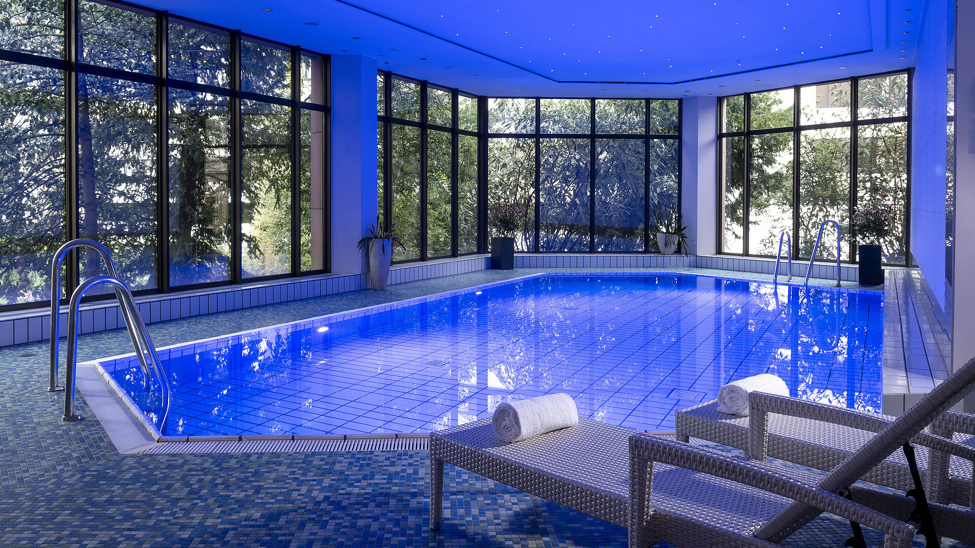 The stylish indoor pool at Maritim Hotel Bad Homburg offers a soothing ambiance with soft lighting and comfortable loungers.