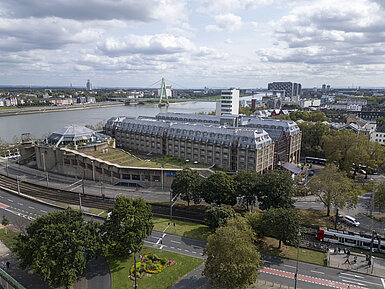 Aerial view of the Maritim Hotel Cologne, featuring the Rhine River, Severins Bridge, and surrounding buildings.