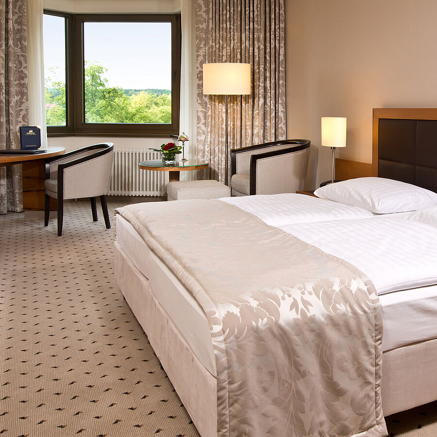 Comfortable hotel room at Maritim Hotel Bad Homburg with modern design and green view.