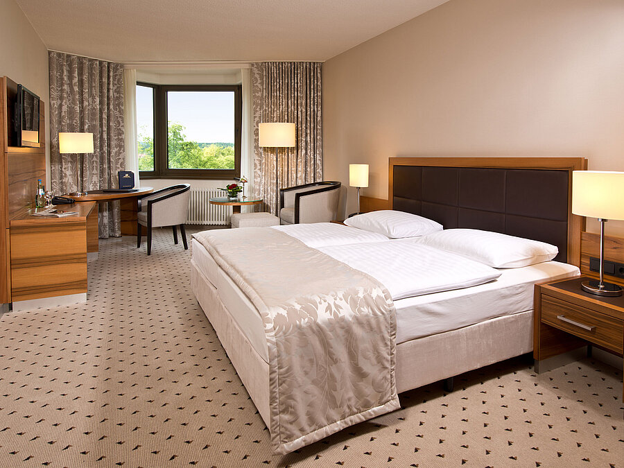 Comfortable hotel room at Maritim Hotel Bad Homburg with modern design and green view.