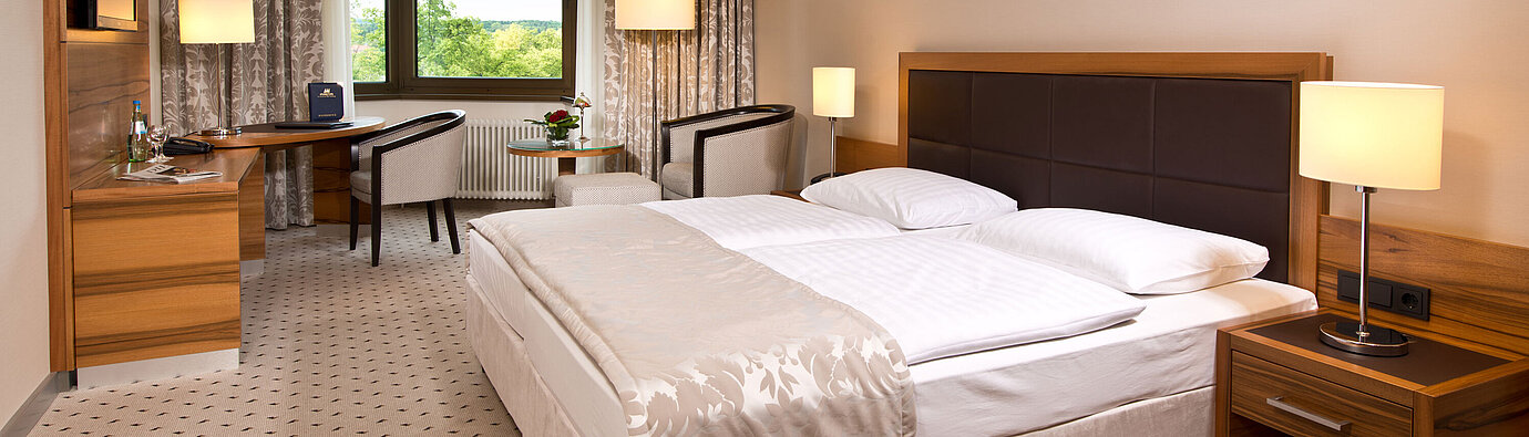 Comfortable hotel room at Maritim Hotel Bad Homburg with modern design and green view.