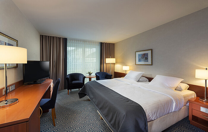 Timeless double room at Maritim Hotel Würzburg with a large bed and welcoming atmosphere