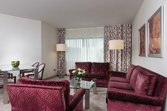 Bright and spacious family suite at the Maritim Hotel Bonn with modern furniture and cozy seating area.