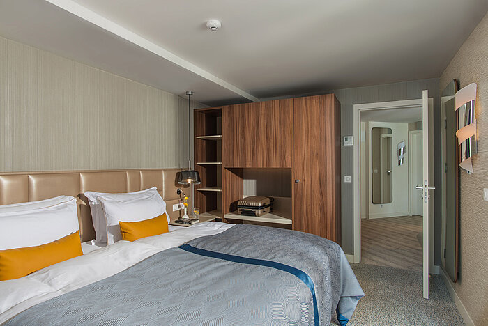 Comfortable room at Maritim Hotel Amelia with large bed, open wardrobe and modern design