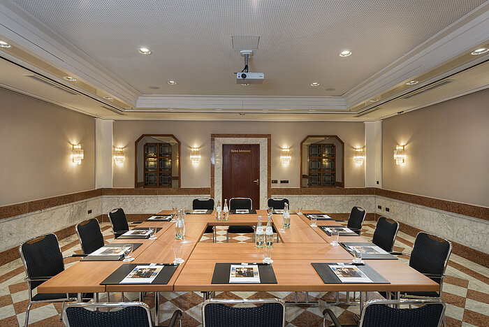 Stylish conference room with U-shaped seating, marble walls, and modern technology at Maritim Hotel Königswinter.