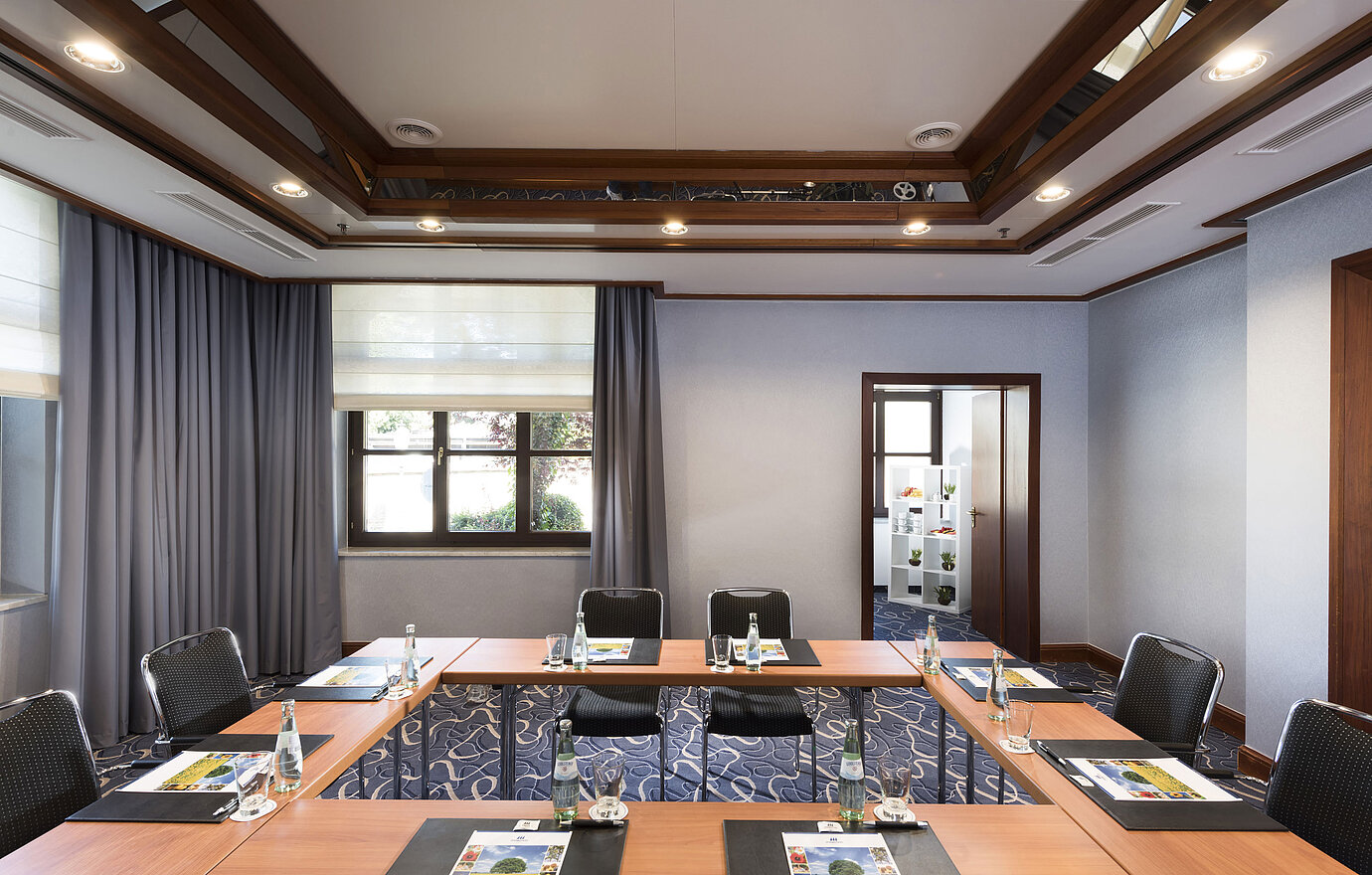 Modern meeting room with natural light, U-shaped seating, and stylish interior at Maritim Hotel Königswinter.