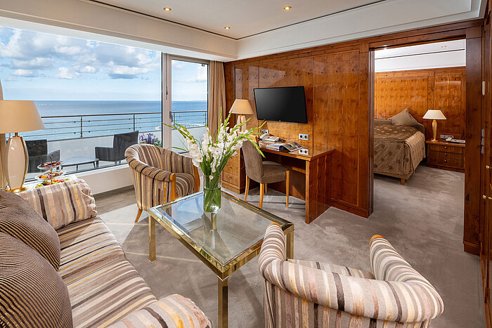 Spacious suite at Maritim Seehotel Timmendorfer Strand with living area, bedroom and sea view