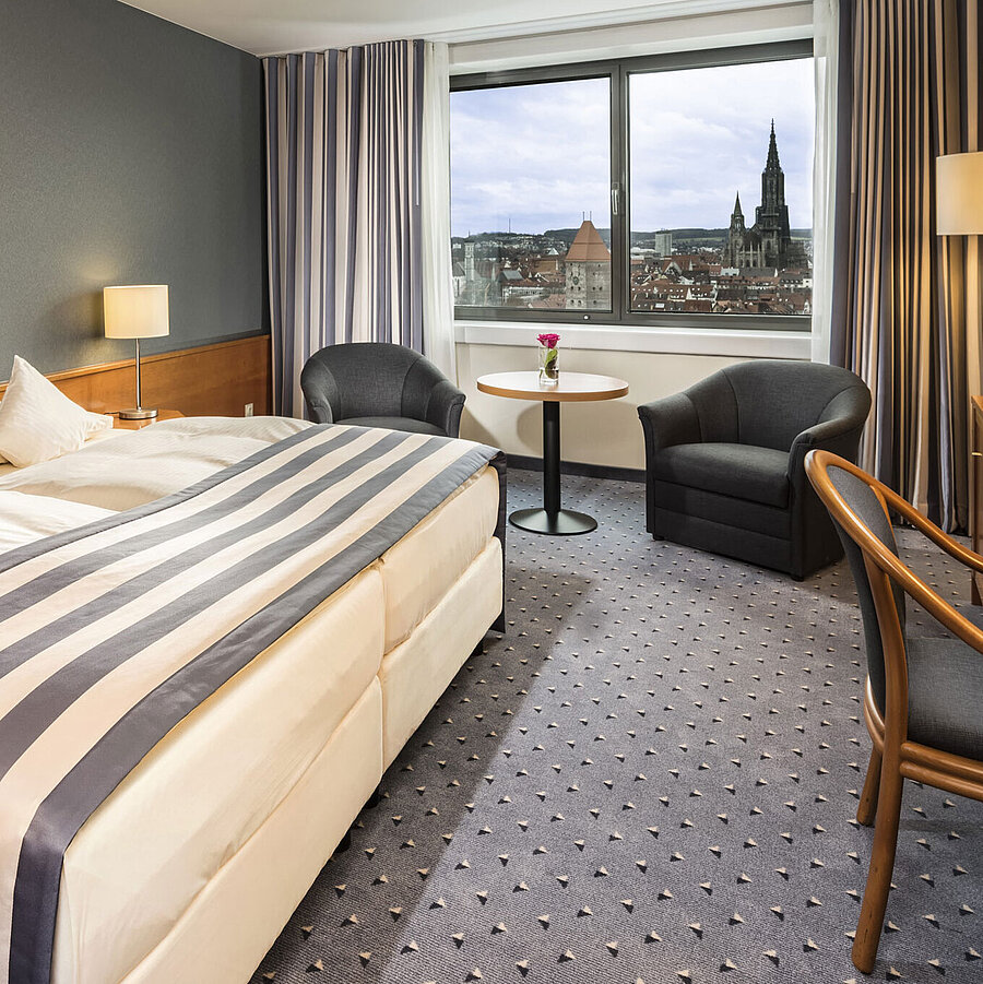 Double room at Maritim Hotel Ulm with panoramic window and view of Ulm Minster