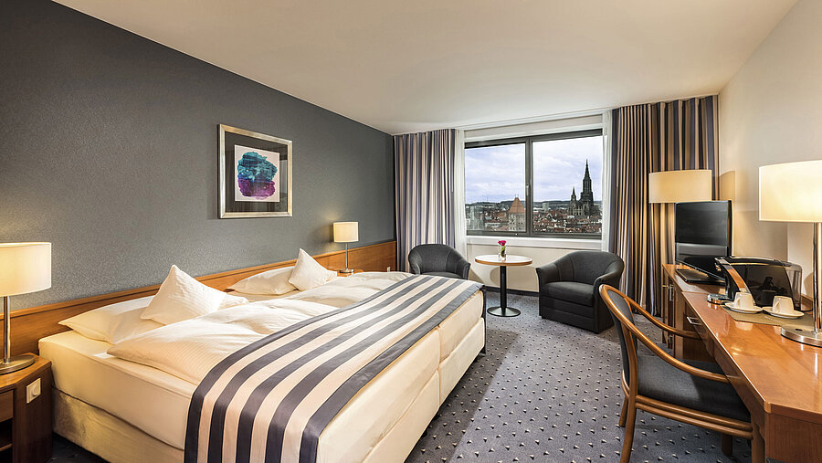 Double room at Maritim Hotel Ulm with panoramic window and view of Ulm Minster