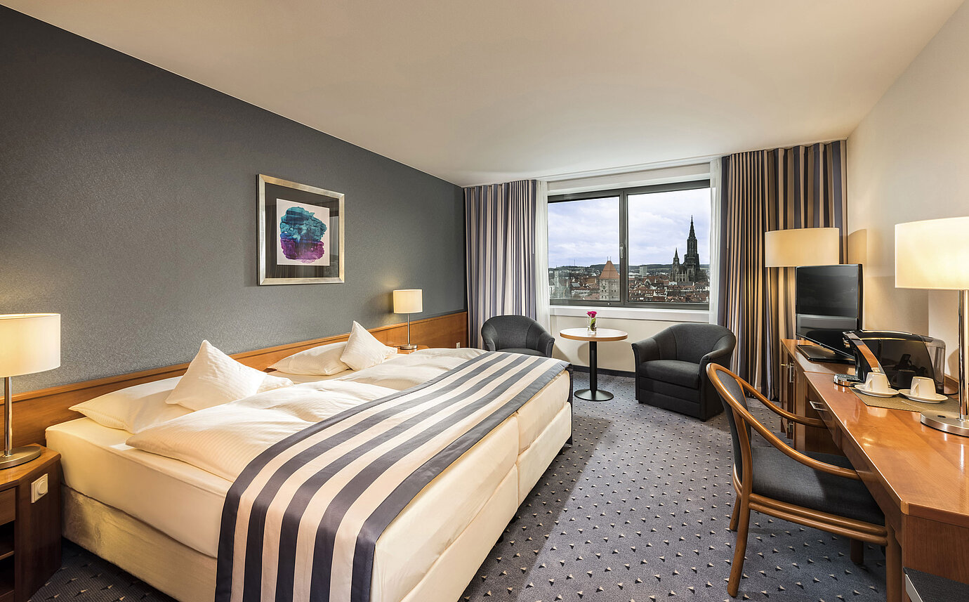 Double room at Maritim Hotel Ulm with panoramic window and view of Ulm Minster