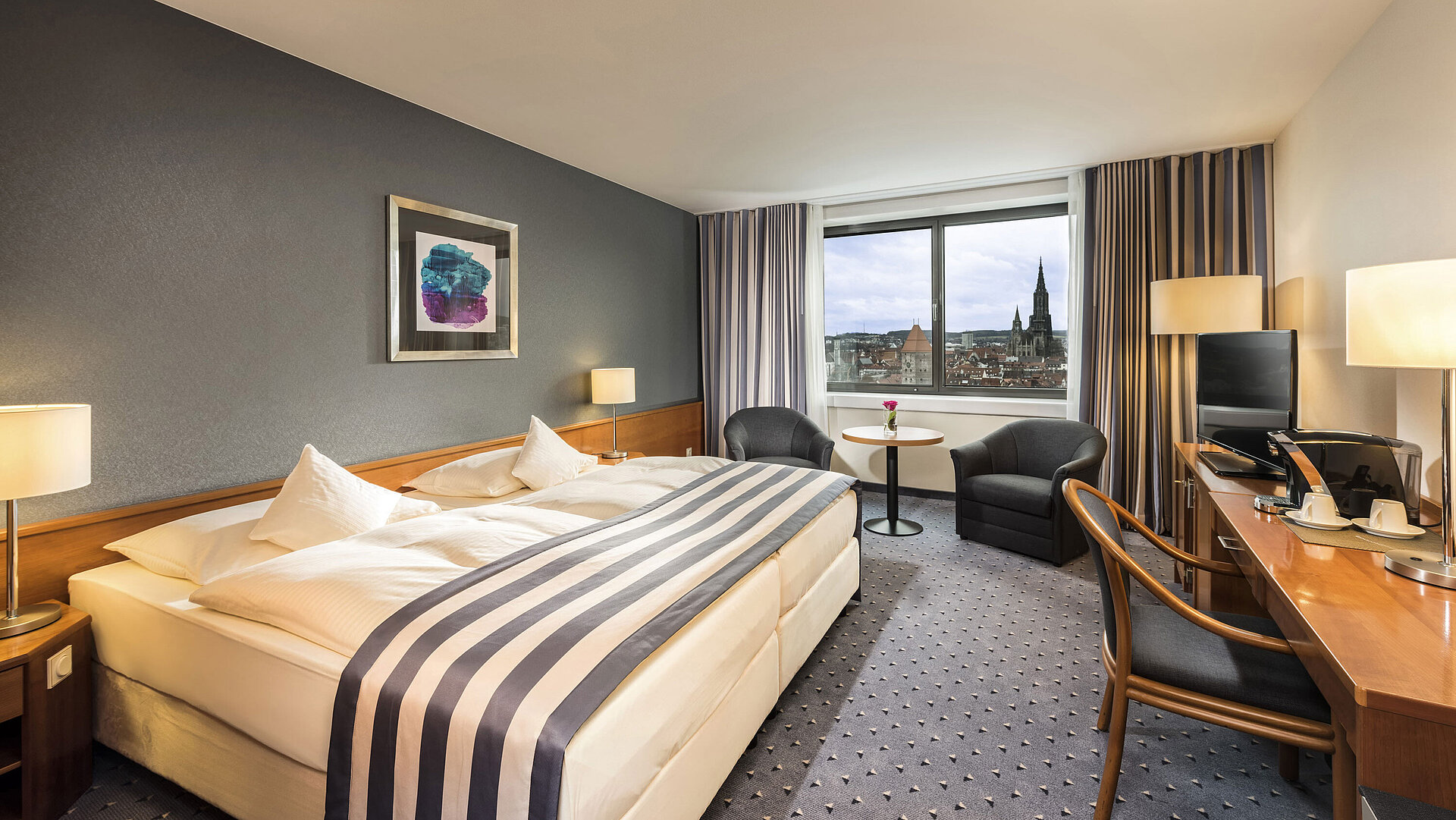 Double room at Maritim Hotel Ulm with panoramic window and view of Ulm Minster