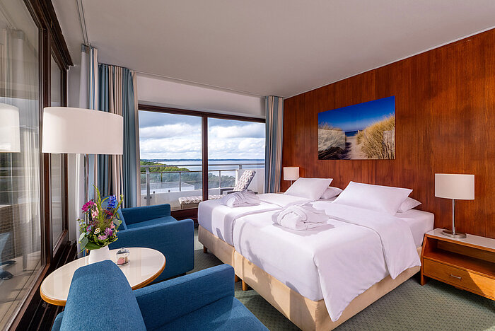 SuperiorPlus Family Room facing the park with double bed, seating area and large windows overlooking the greenery