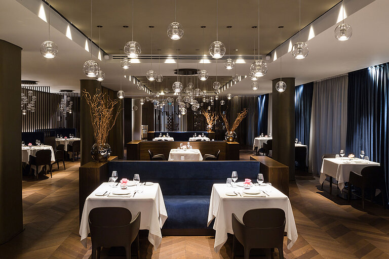 Elegant restaurant with modern design and stylish lighting at Maritim Hotel Plaza Tirana