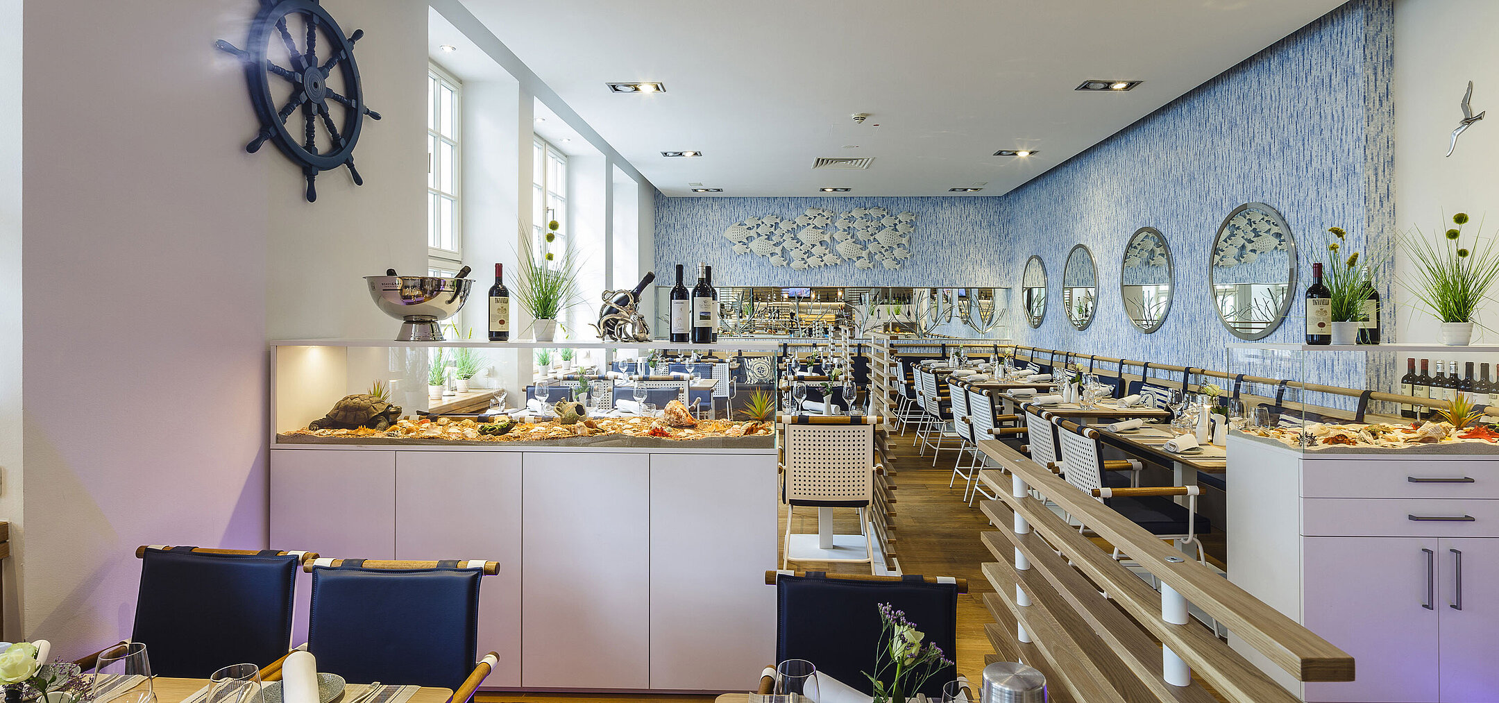 Bright hotel restaurant with fish buffet, modern design and maritime details