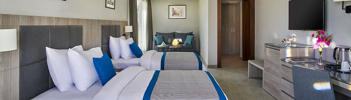 Modern family room at Maritim Jolie Ville Resort & Casino Sharm El Sheikh with two double beds