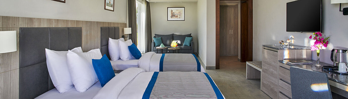 Modern family room at Maritim Jolie Ville Resort & Casino Sharm El Sheikh with two double beds
