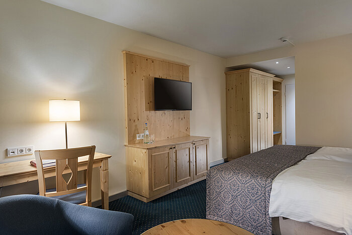 Room at Maritim TitiseeHotel with wooden furniture, desk and TV