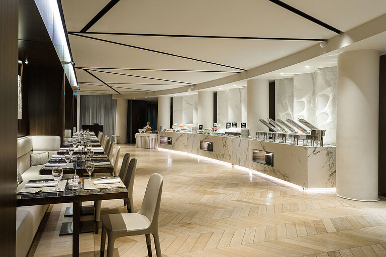 Spacious restaurant with buffet and stylish seating at Maritim Hotel Plaza Tirana