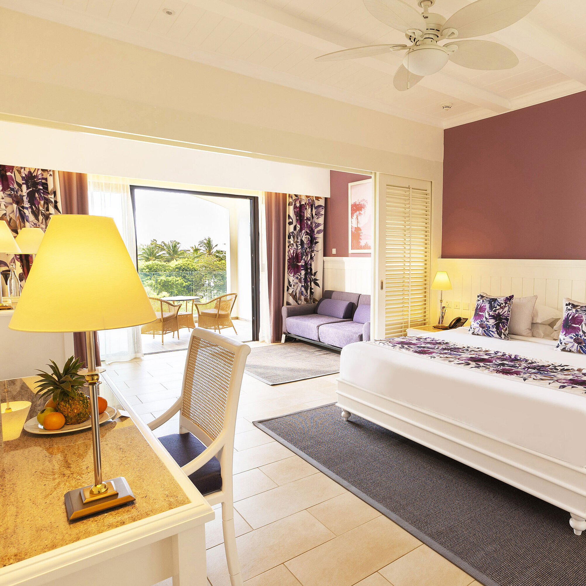 Room with a king-size bed, stylish furniture, and access to the terrace with a sea view