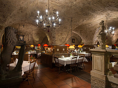 Historic restaurant at Maritim Hotel Fulda with vaulted ceiling, candlelight, and rustic ambiance.