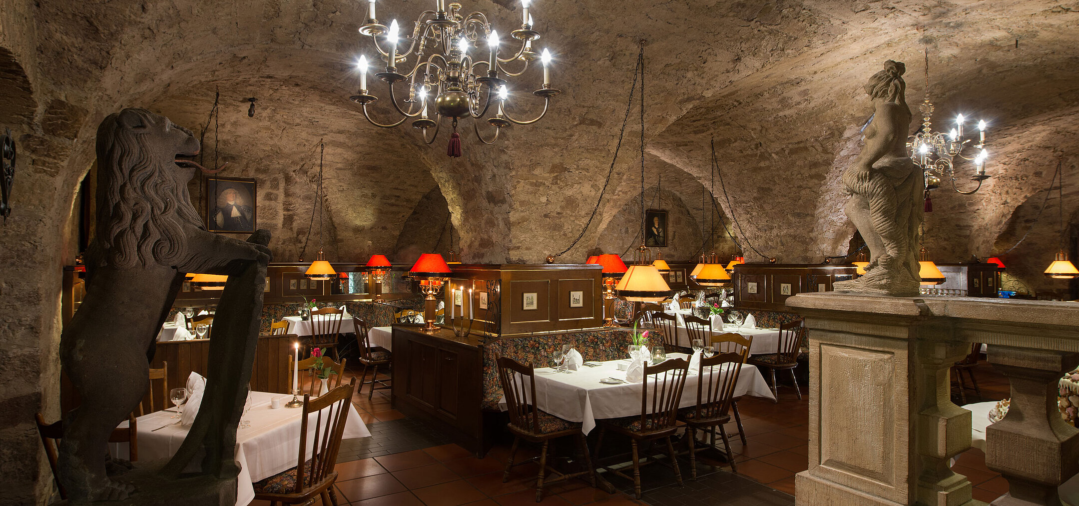 Historic restaurant at Maritim Hotel Fulda with vaulted ceiling, candlelight, and rustic ambiance.