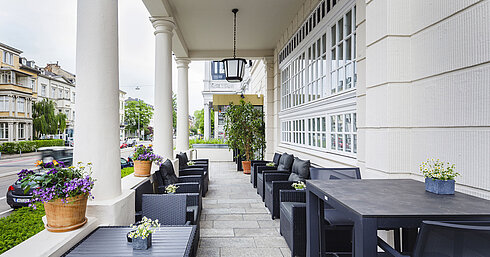 Terrace of Hansa Hotel Wiesbaden with seating and columns