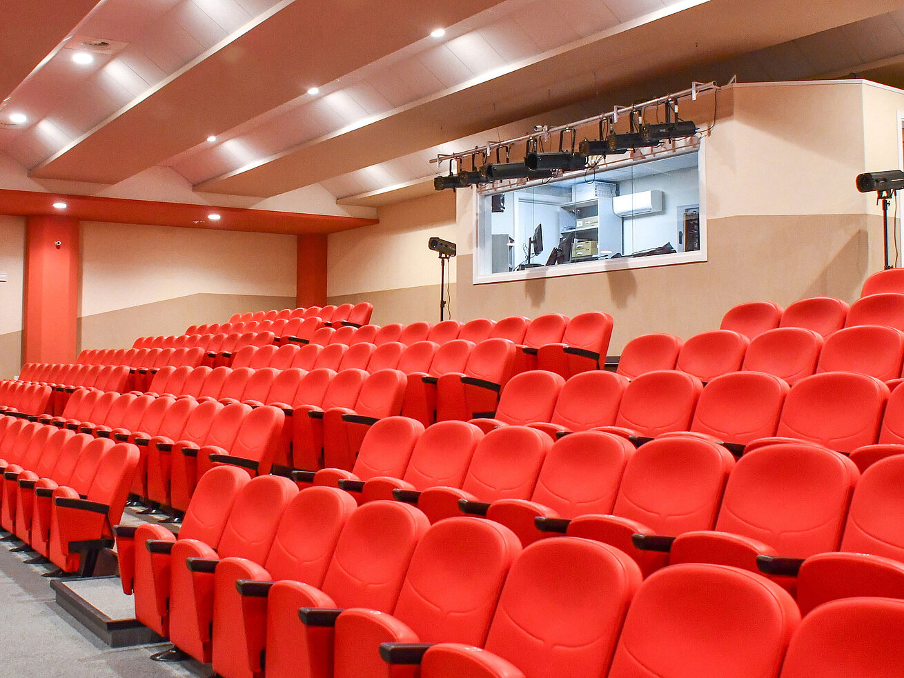 Theatre hall with red seats and tech room at Maritim Resort Calabria