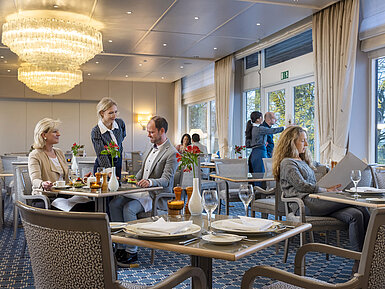 The Bellevue restaurant in the Maritim Hotel Kiel with elegant interior, friendly service and relaxed guests.