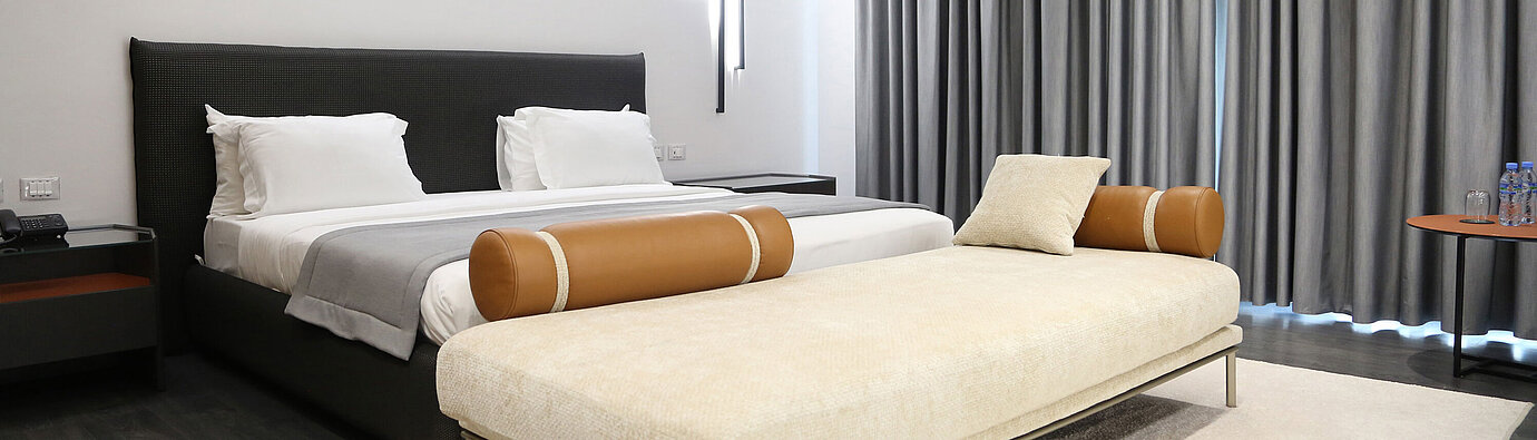 Bright double room at Maritim Resort Marina Bay with modern design and large sofa