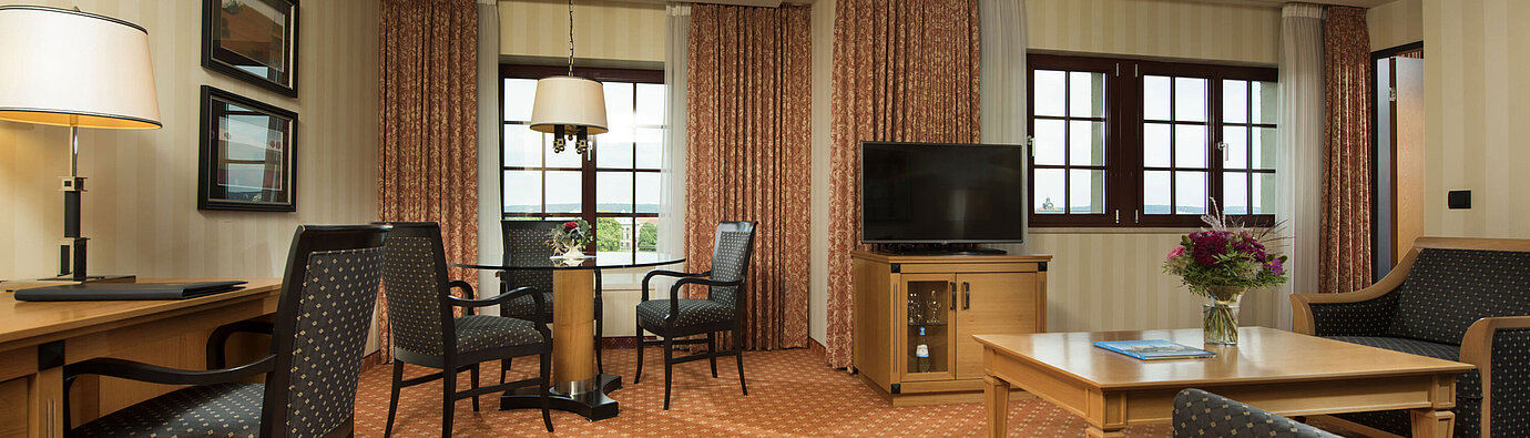 Junior Suite at Maritim Hotel Dresden with stylish seating area, large desk, and modern design.