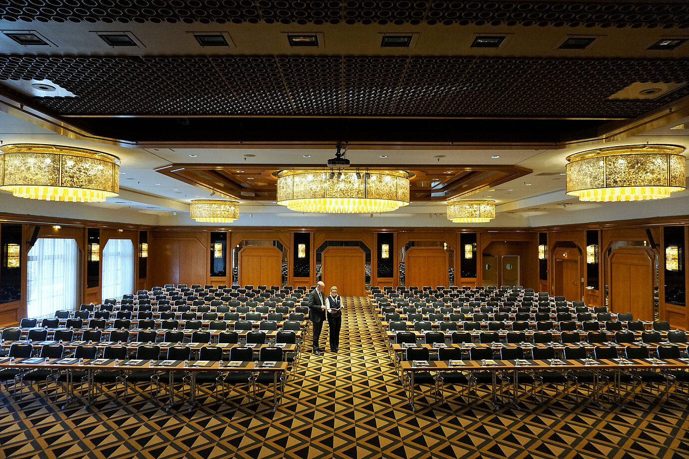 Elegant conference hall at Maritim Hotel Königswinter with modern seating and impressive chandeliers.