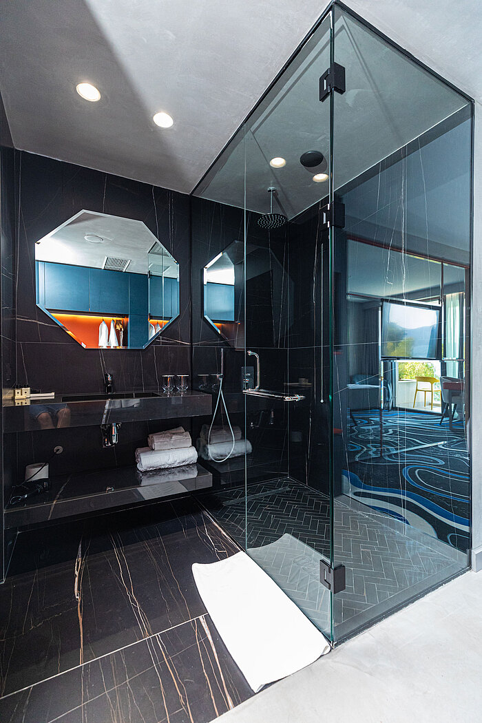 Elegant bathroom at Maritim Resort Marina Bay with black design, glass shower and mirror