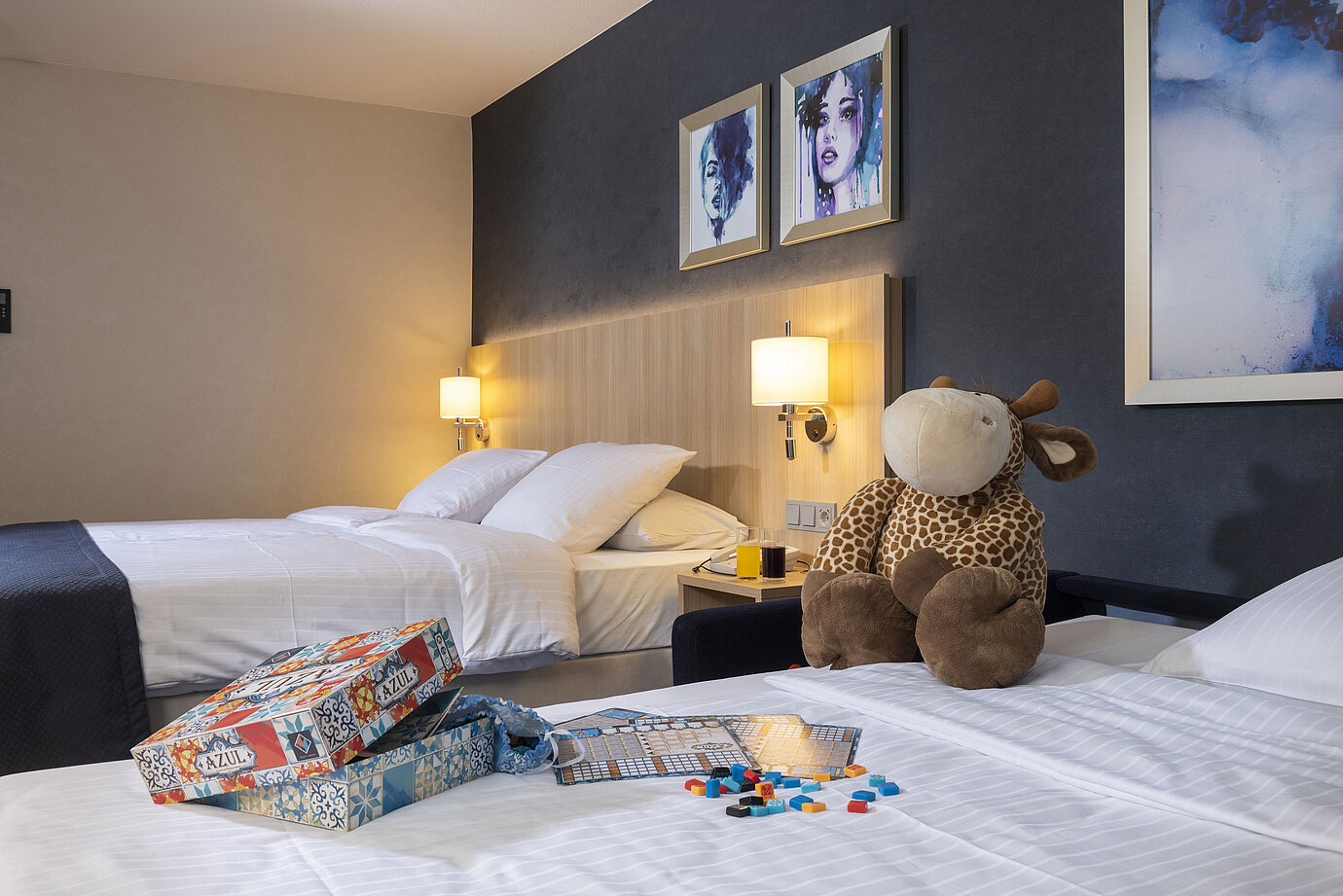 Comfort family room at Maritim Hotel Würzburg with plush toy and colorful board game