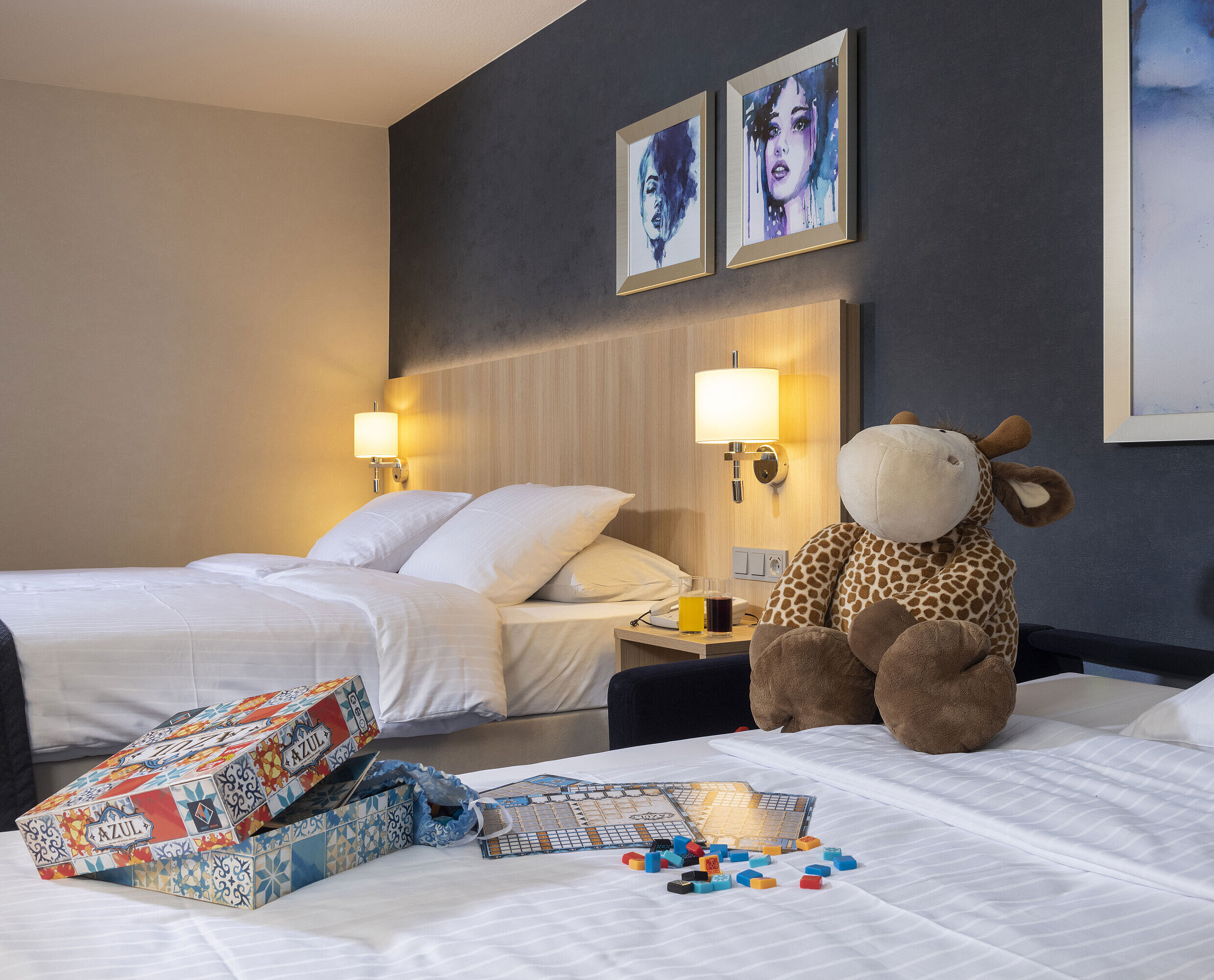Comfort family room at Maritim Hotel Würzburg with plush toy and colorful board game