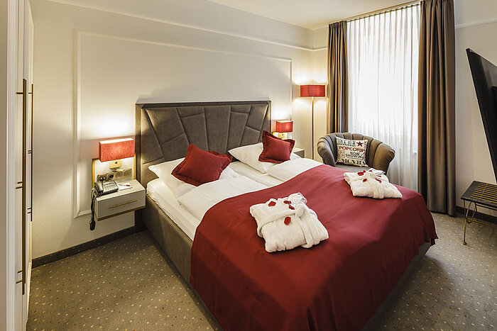 Comfortable double room with bathrobes and cosy lighting at Hansa Hotel Wiesbaden